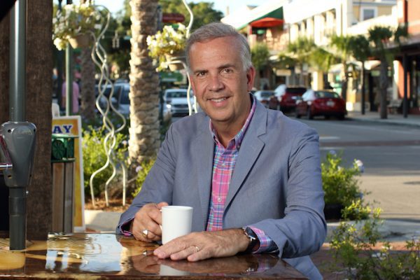 Steven Alexander sitting at a coffee table